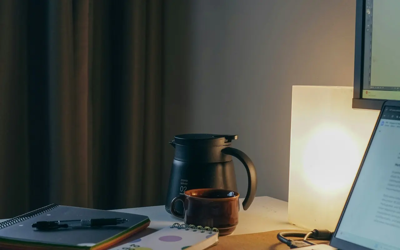 Laptop, notebook and coffee arranged on a work desk